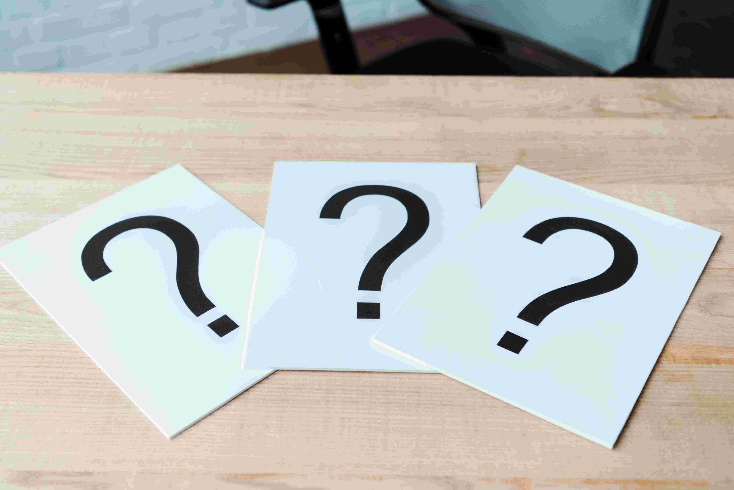 black-question-marks-on-white-papers-on-wooden-tab-2024-11-09-05-33-06-utc
