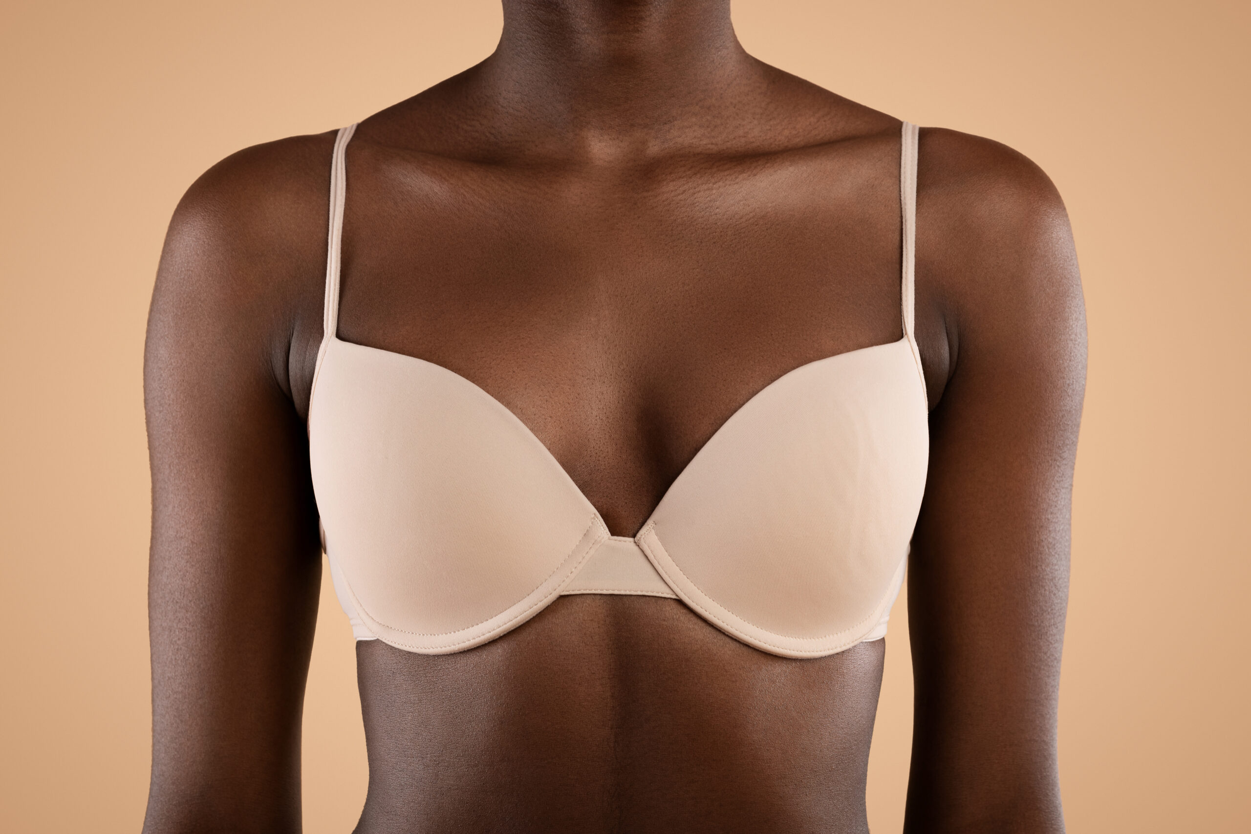 Breast of unrecognizable young black woman, closeup photo